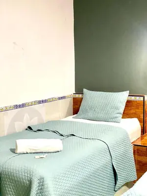 two beds sitting next to each other in a room at hotel marsella in Sonsonate