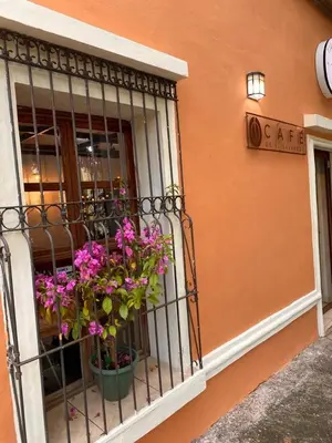 a balcony with purple flowers on a building at Bed and breakfast Tía Mema in Santa Ana