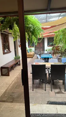 a patio with a table and chairs and a table and chairs at Bed and breakfast Tía Mema in Santa Ana