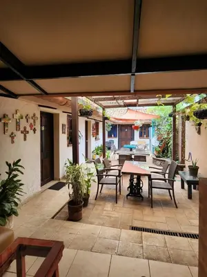 an outdoor patio with a table and chairs at Bed and breakfast Tía Mema in Santa Ana